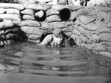 Recruit emerging from original Endurance Course water tunnel.